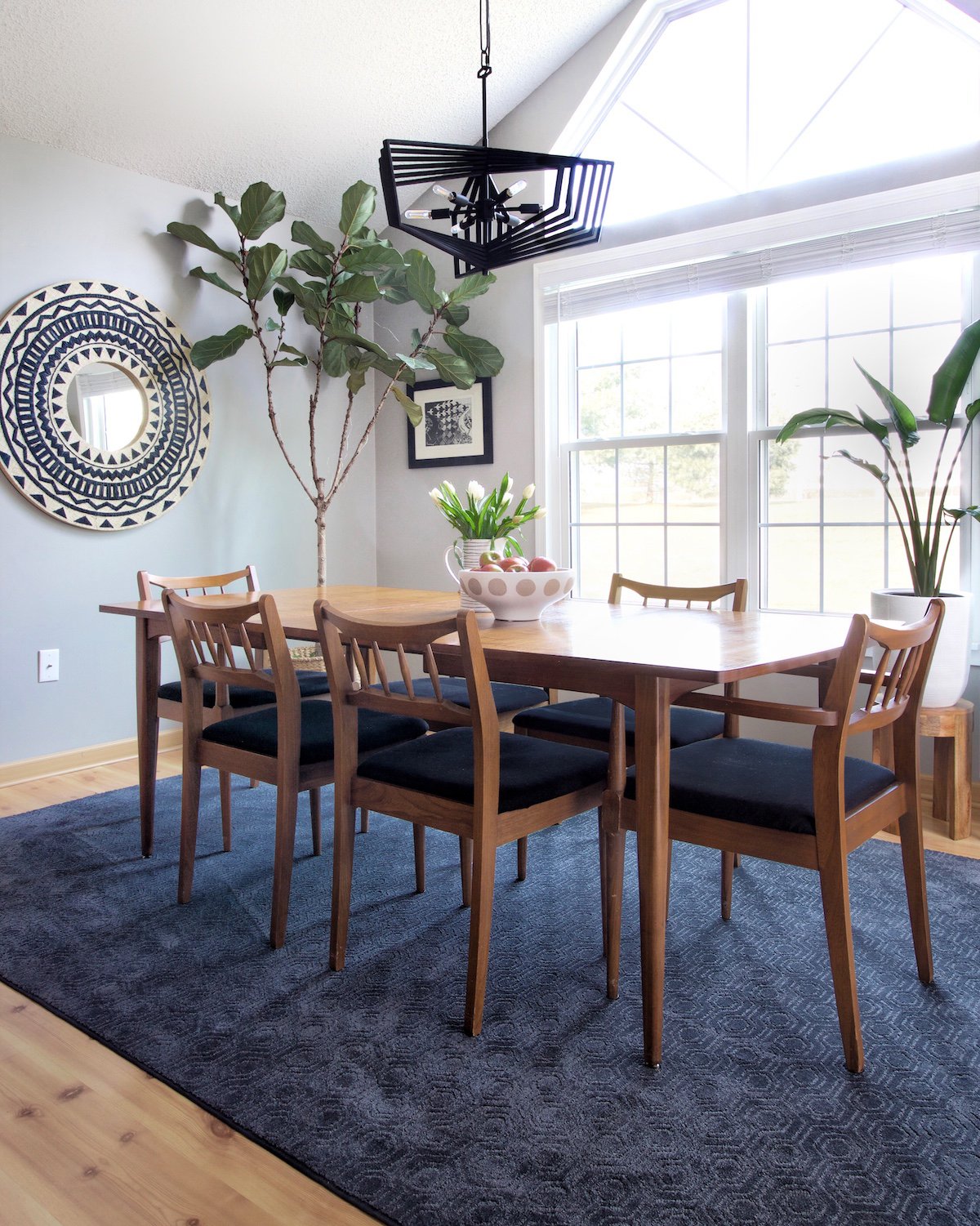 Blue area rug under modern dining room table