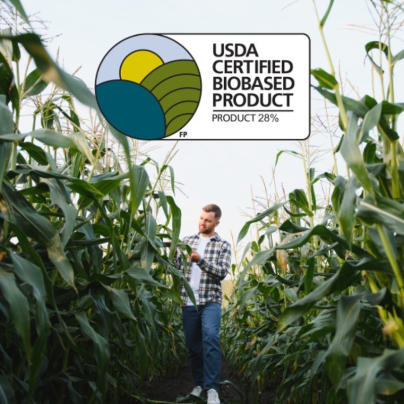 Man picking corn in a corn field used for SmartStrand carpet fibers