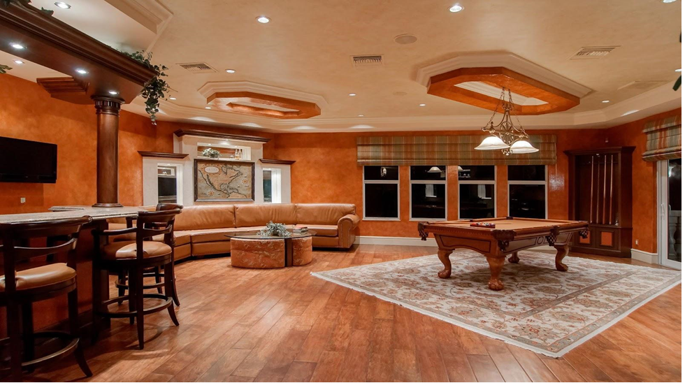 Large game room with warm laminate flooring